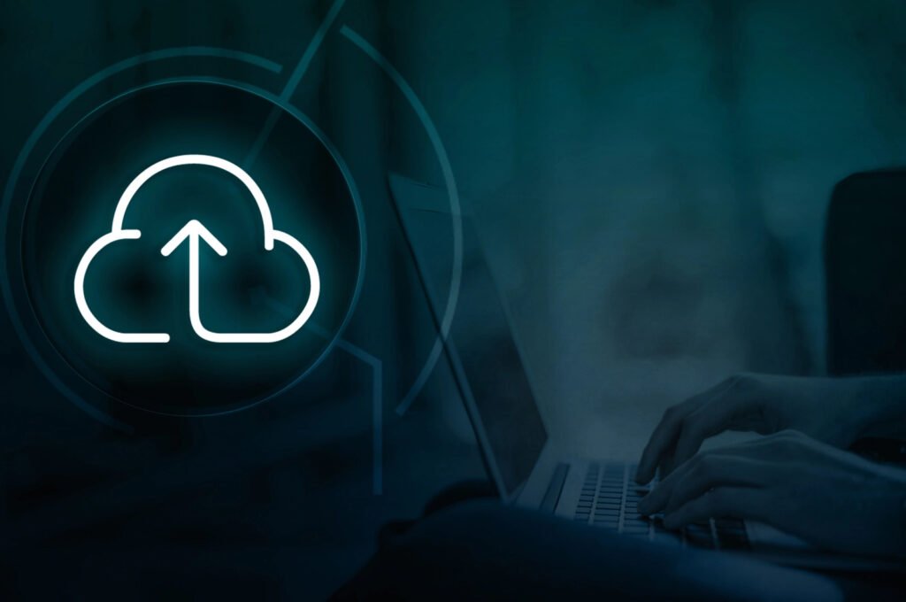 Hands diligently typing on a laptop, as a glowing cloud upload icon overlays the screen, seamlessly integrating AWS CodeDeploy for streamlined application deployments.